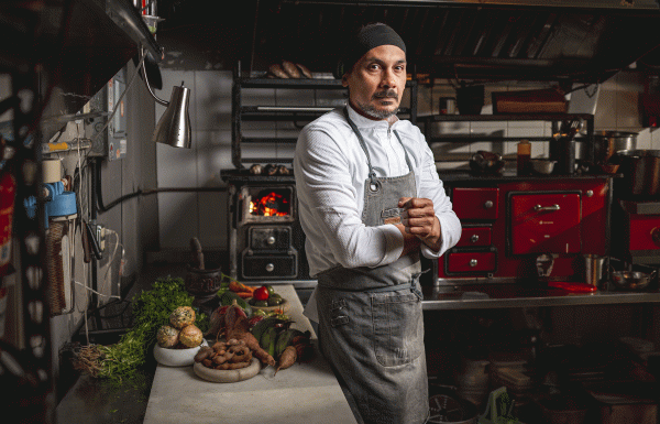 Chef Carlos Portela poses in his kitchen