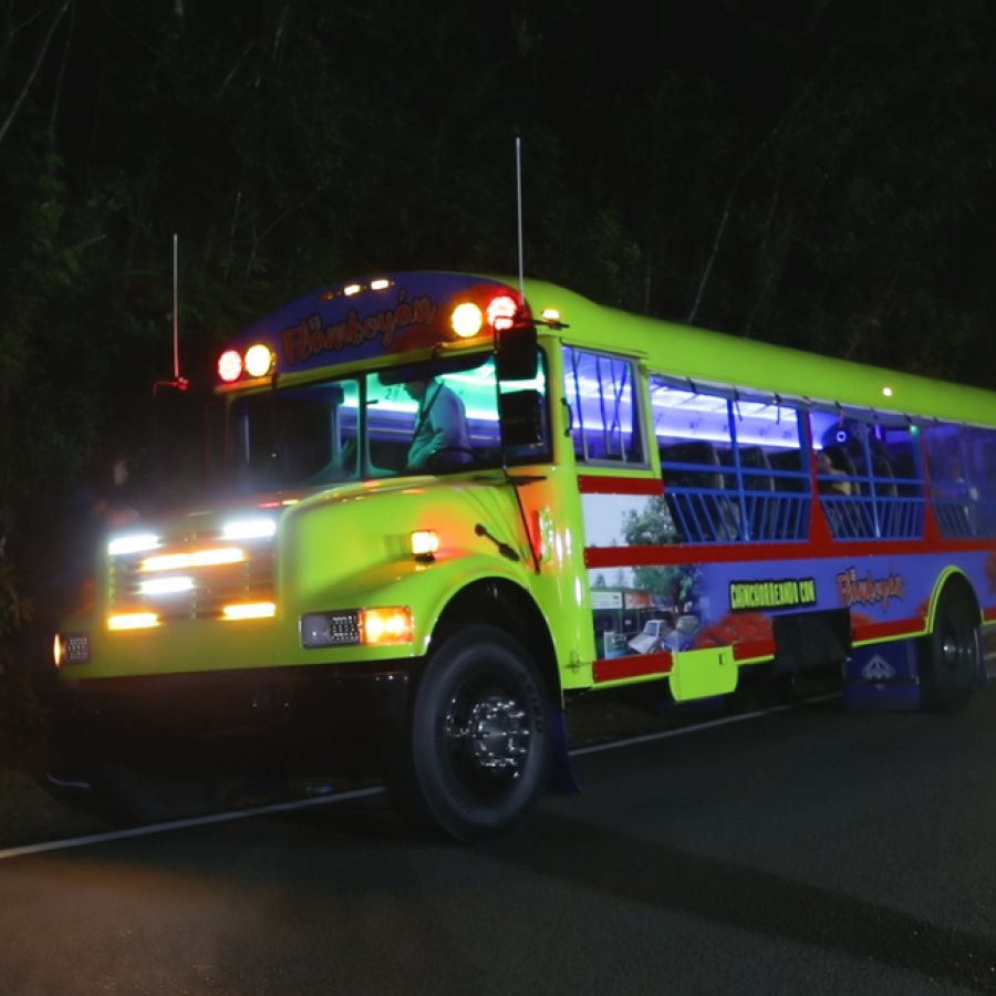 A vibrant Chinchorreo bus waits for its passengers to finish up at their latest stop.