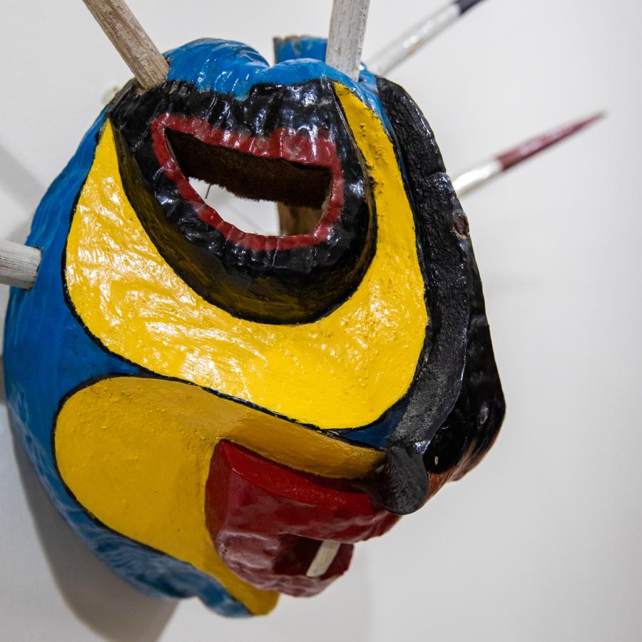 A colorful vejigante mask hangs on the wall of the museum in Loiza