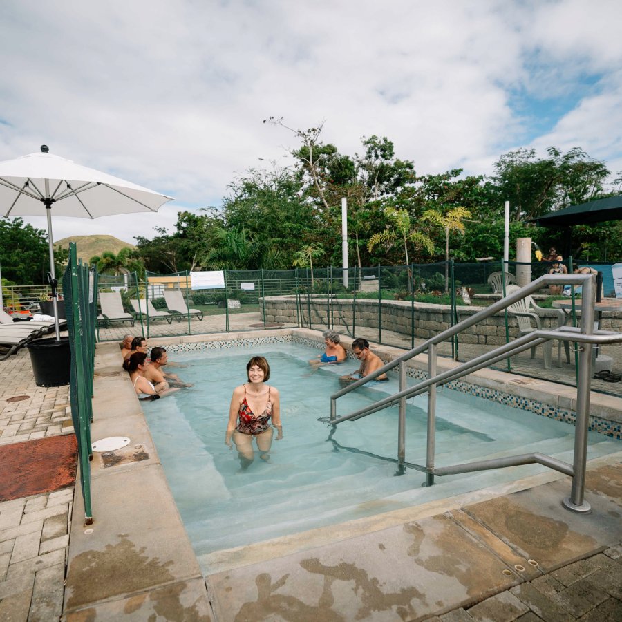 A woman gets out of the hot spring pool