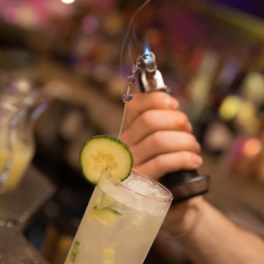 A bartender prepares an elaborate craft cocktail at Gallo Negro.