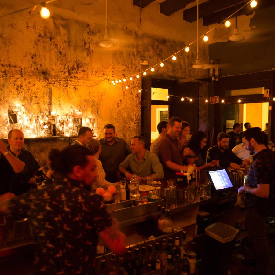 A packed bar under dim lights at La Factoria in Old San Juan.