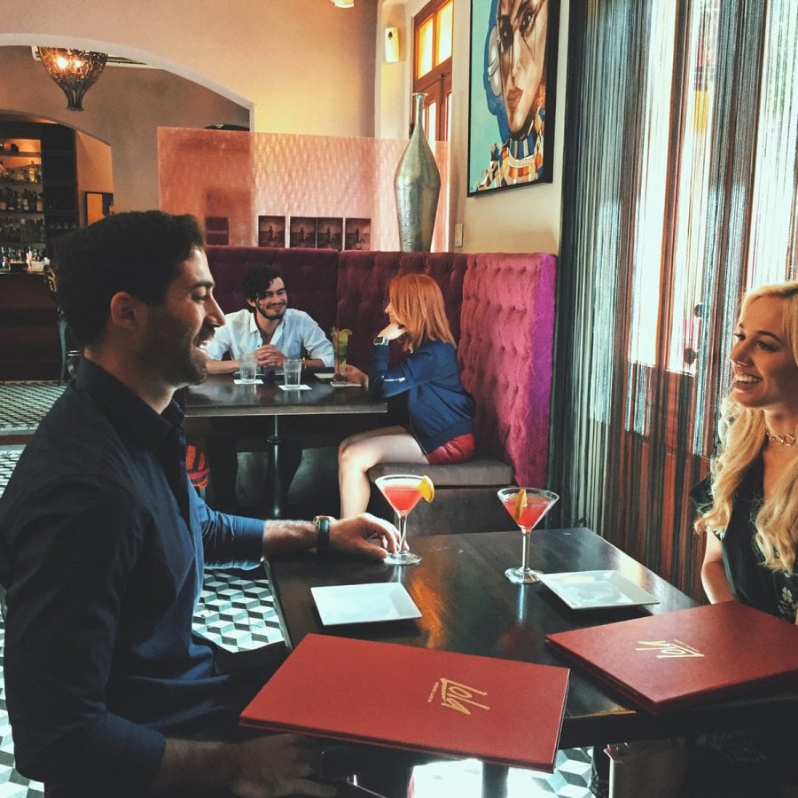 A couple enjoys their cocktails at a restaurant in Ponce.