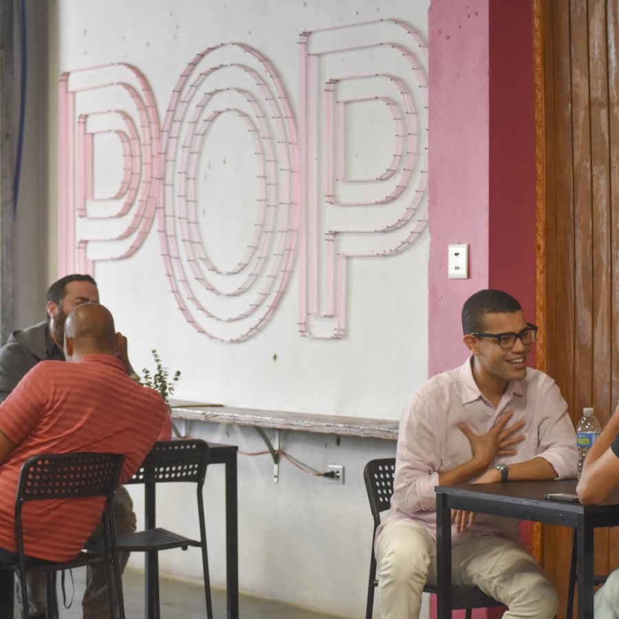 people sitting at tables and talking in POP in Santurce