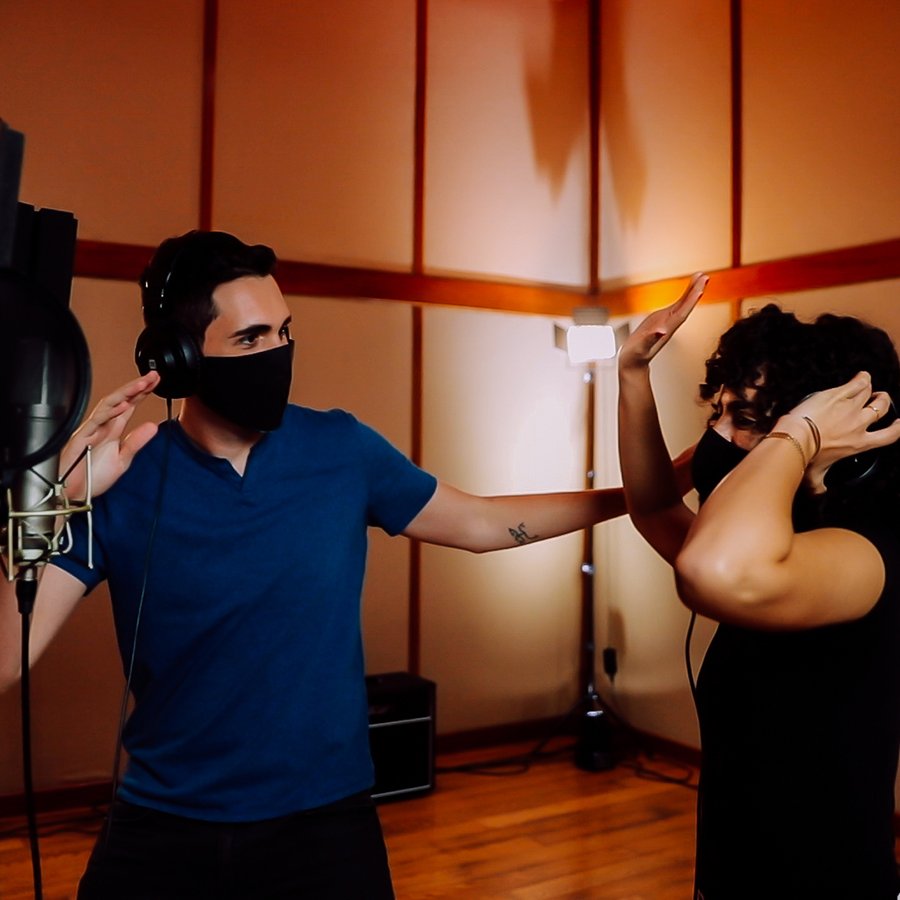 A couple enjoying reggaeton music in a studio.