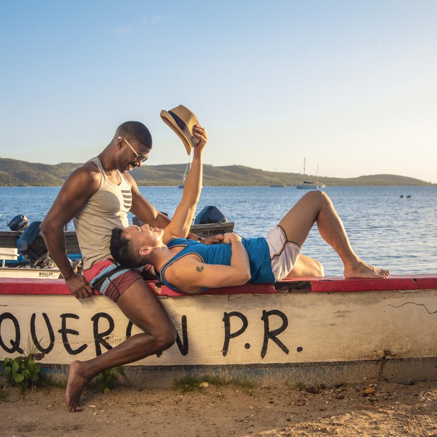 Una pareja posa junto a un barco