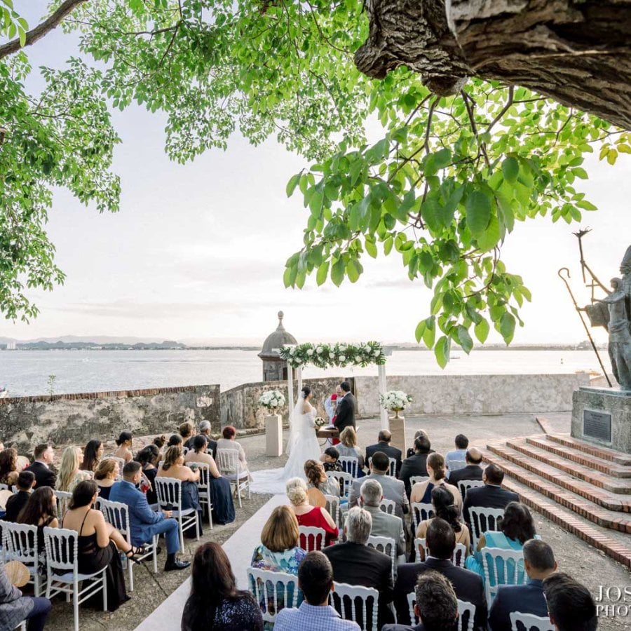 Invitados sentados para una boda frente a la icónica estatua de La Rogativa en el Viejo San Juan.