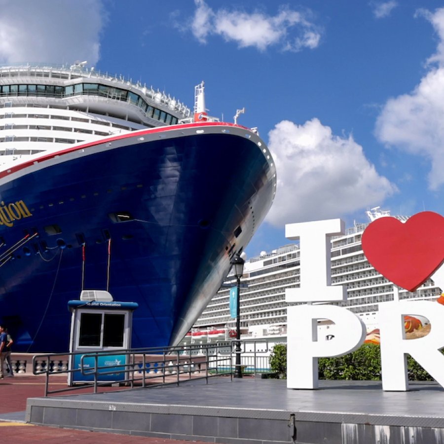 The "I Love PR" sign in front of a large cruise ship at the Old San Juan Port.