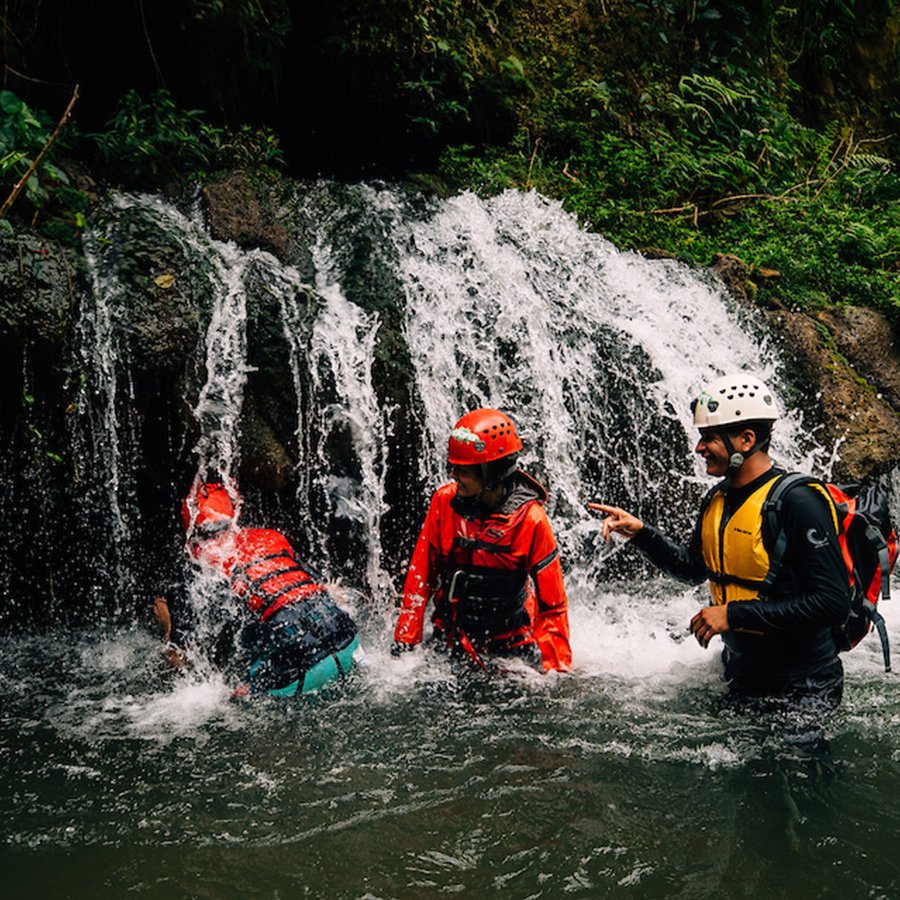 Un grupo de cuatro personas haciendo tubing y explorando el Río Tanamá.