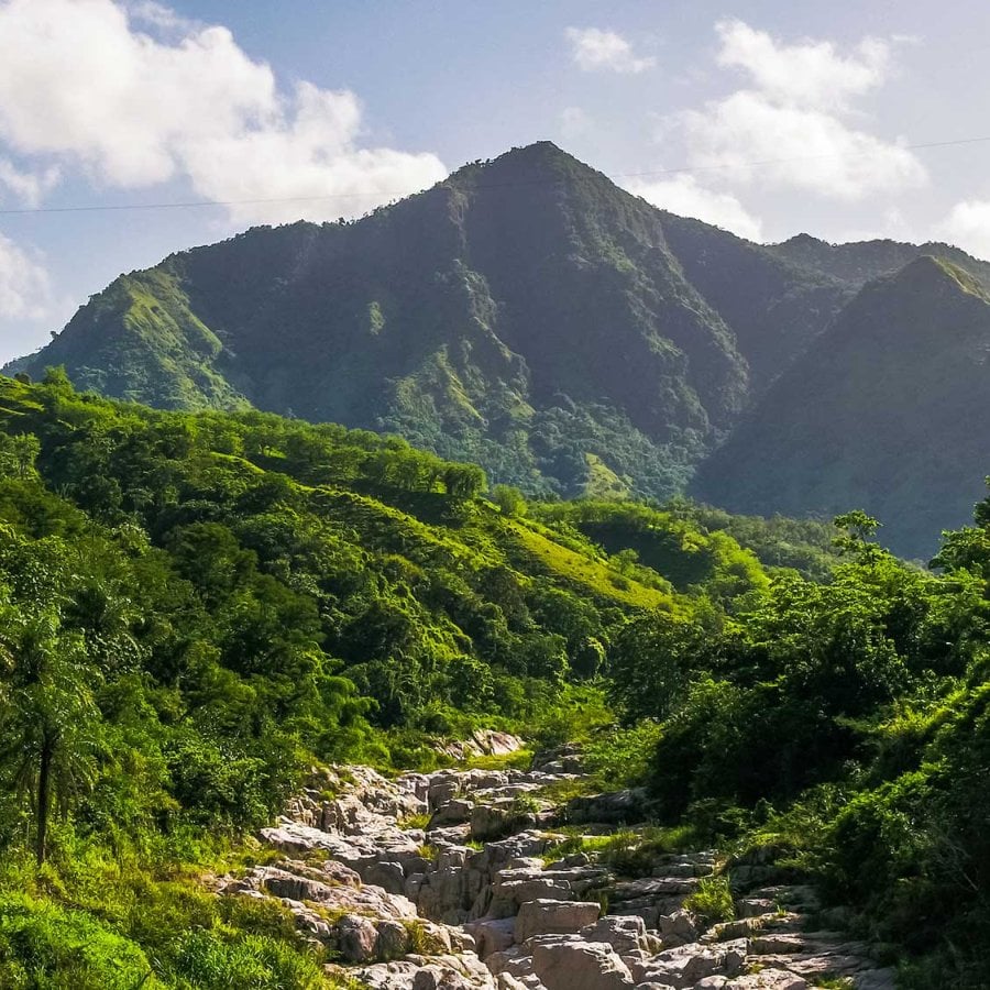 A stunning mountain landscape in Utuado, Puerto Rico, with the dramatic rock formations of Canon Blanco in the foreground.