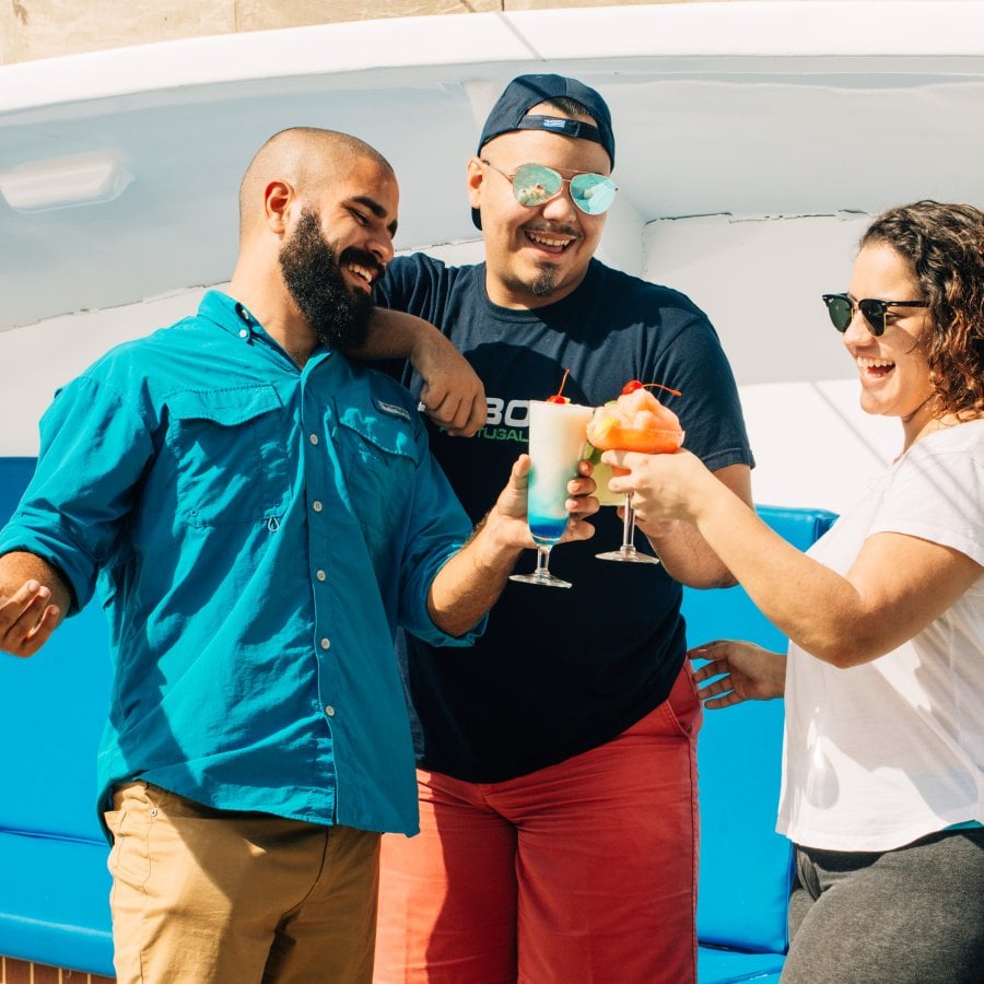 Group of people cheering with drinks.