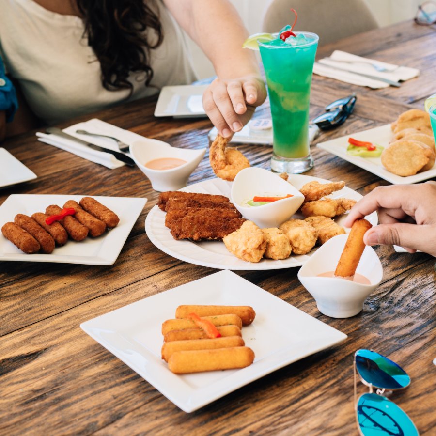 Dinner table filled with appetizers and drinks.