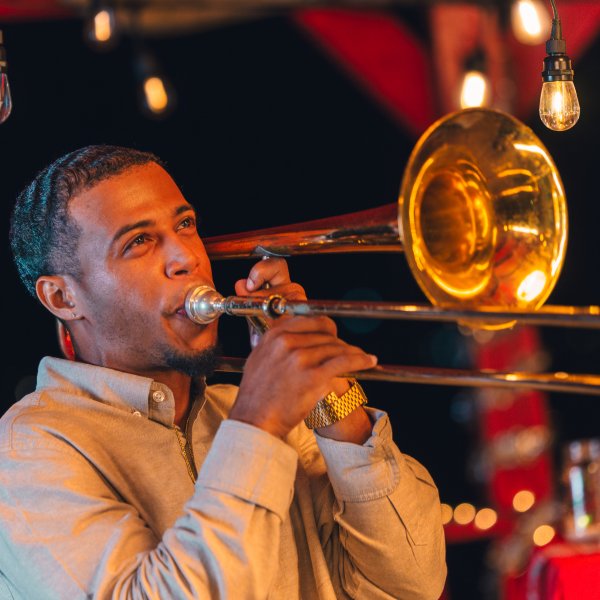 Trombone player performing live on stage.