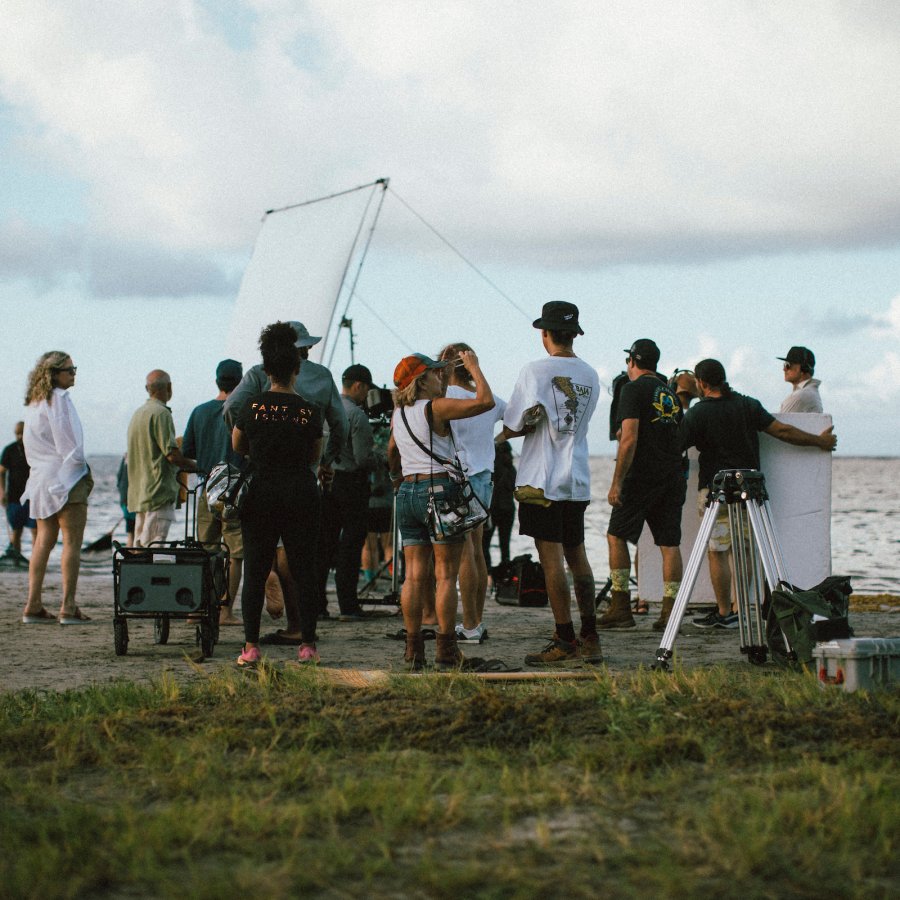 Group filming at the beach.