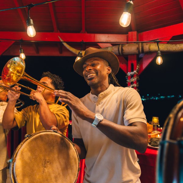 A group of people playing tambourines and the trumpet.