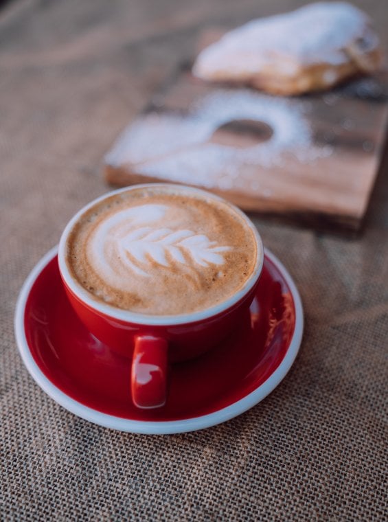 A cup of Puerto Rican coffee and a pastry.