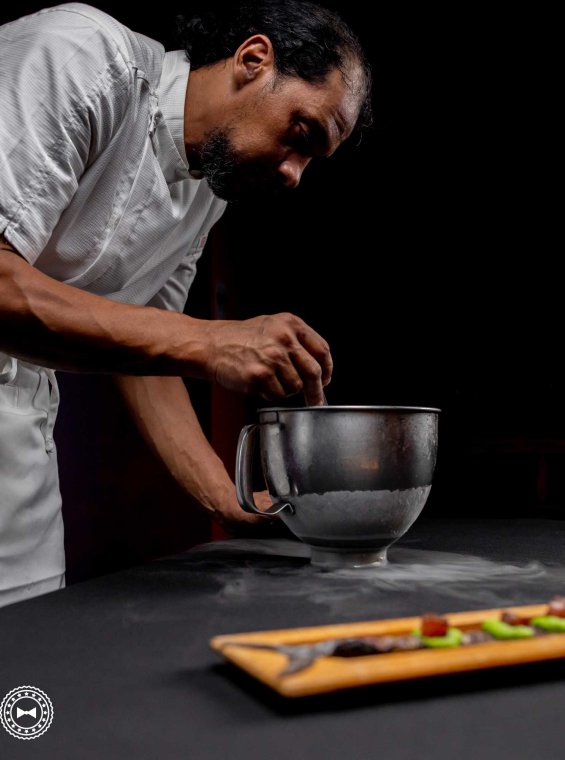 Chef Portela crafting a dish at Orujo Restaurant